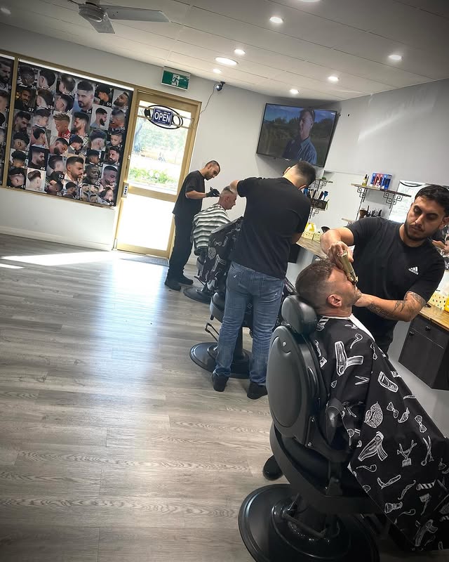 Inside Barberz Den barbershop in Kiara — barbers working with clients